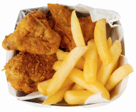 Close-up of a carton of french-fries and chicken